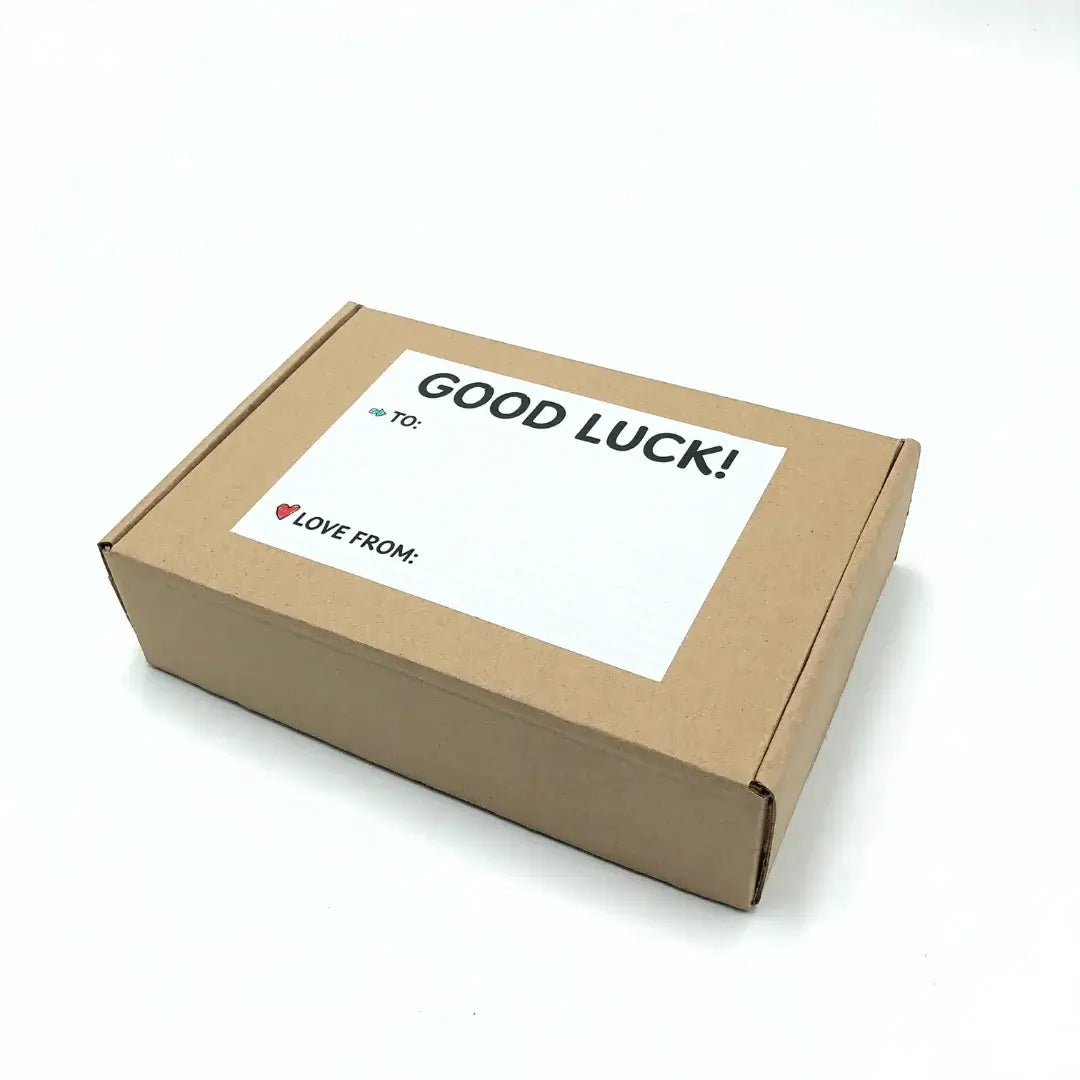 Exam Care Package with a label saying 'GOOD LUCK!' on a brown box.