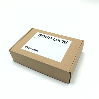 Exam Care Package with a label saying 'GOOD LUCK!' on a brown box.