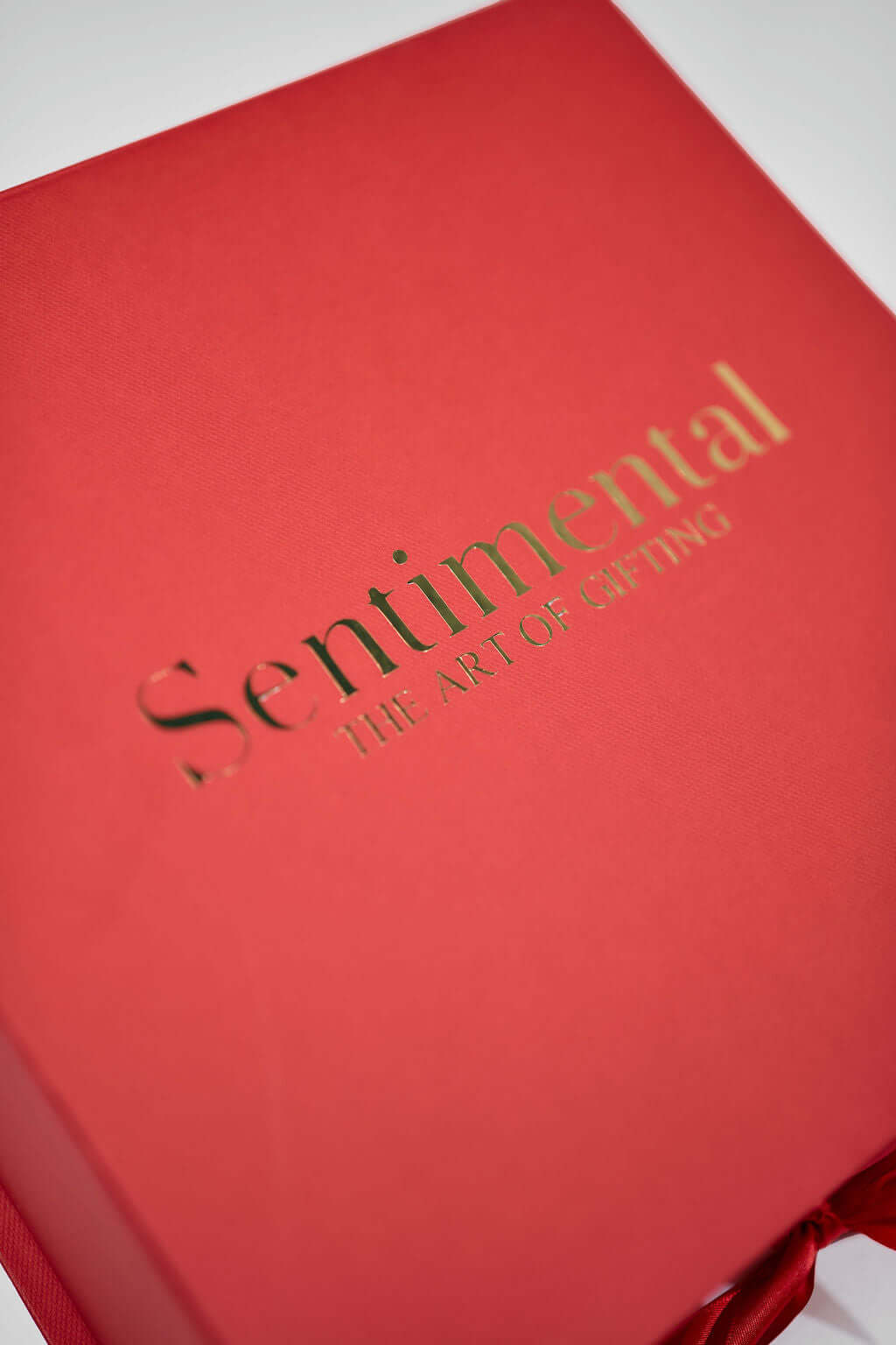 Close-up of a red gift box labeled 'Sentimental - The Art of Gifting'. Perfect for thoughtful presents.