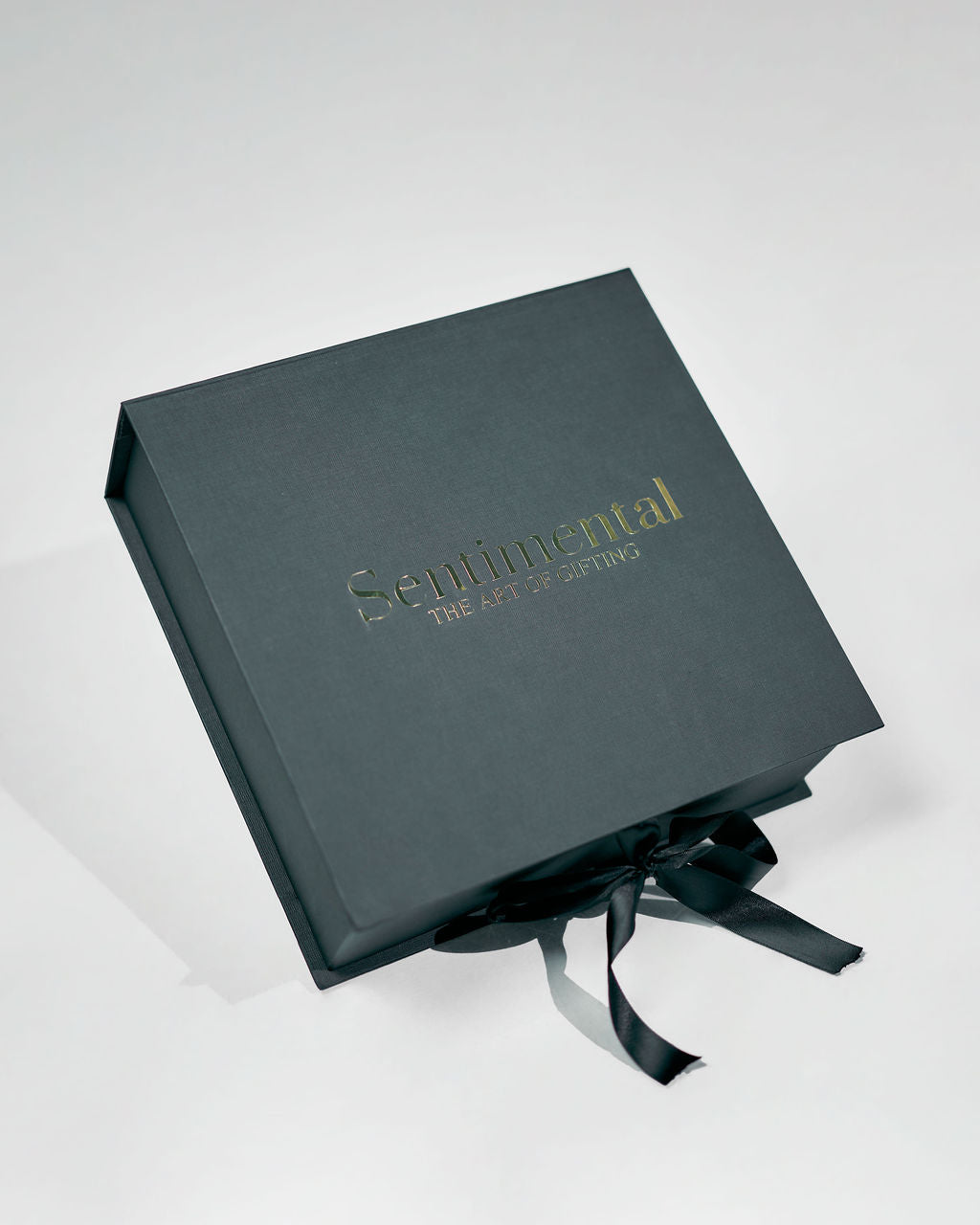 Nice to Treat You Giftbox elegantly presented with a black box adorned with a ribbon for gifting.