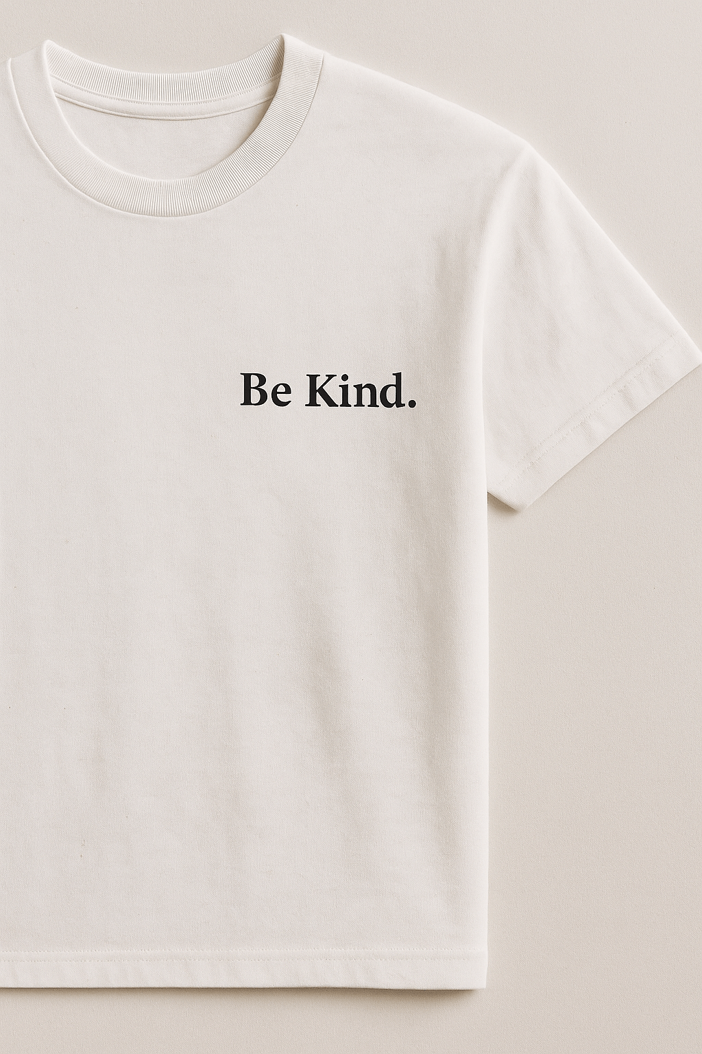 Be Kind T-shirt featuring a minimalist design with the text 'Be Kind.' printed on a soft, white fabric.